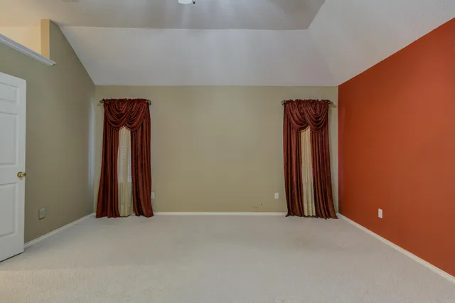 a bathroom with a granite countertop double vanity sink a shower and a mirror