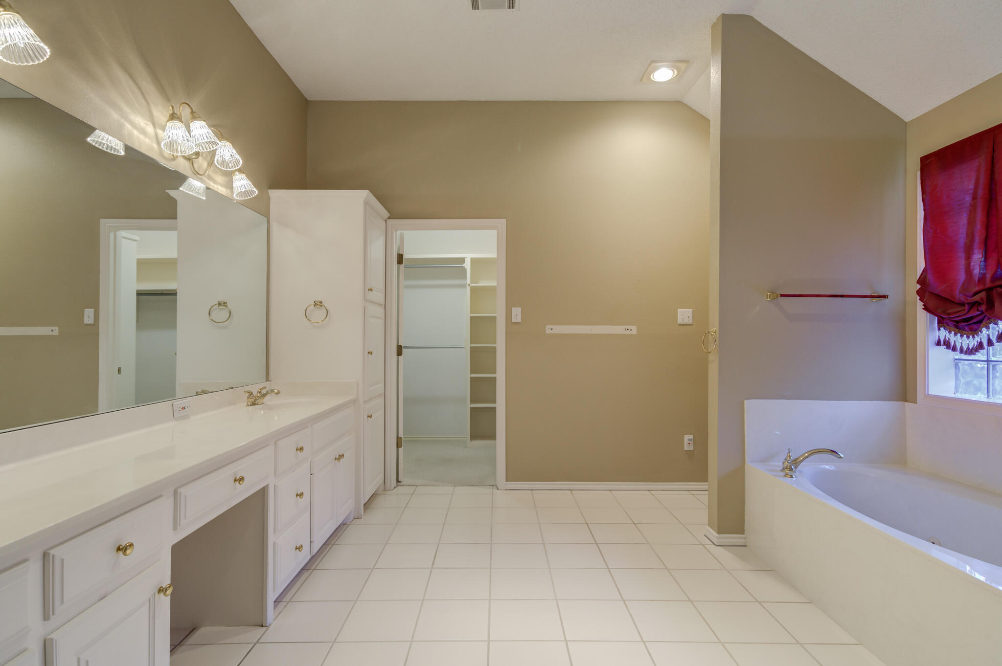 5917 85th Street Lubbock, TX 79424 - Photo 32 of 51 a spacious bathroom with a shower a sink and a mirror