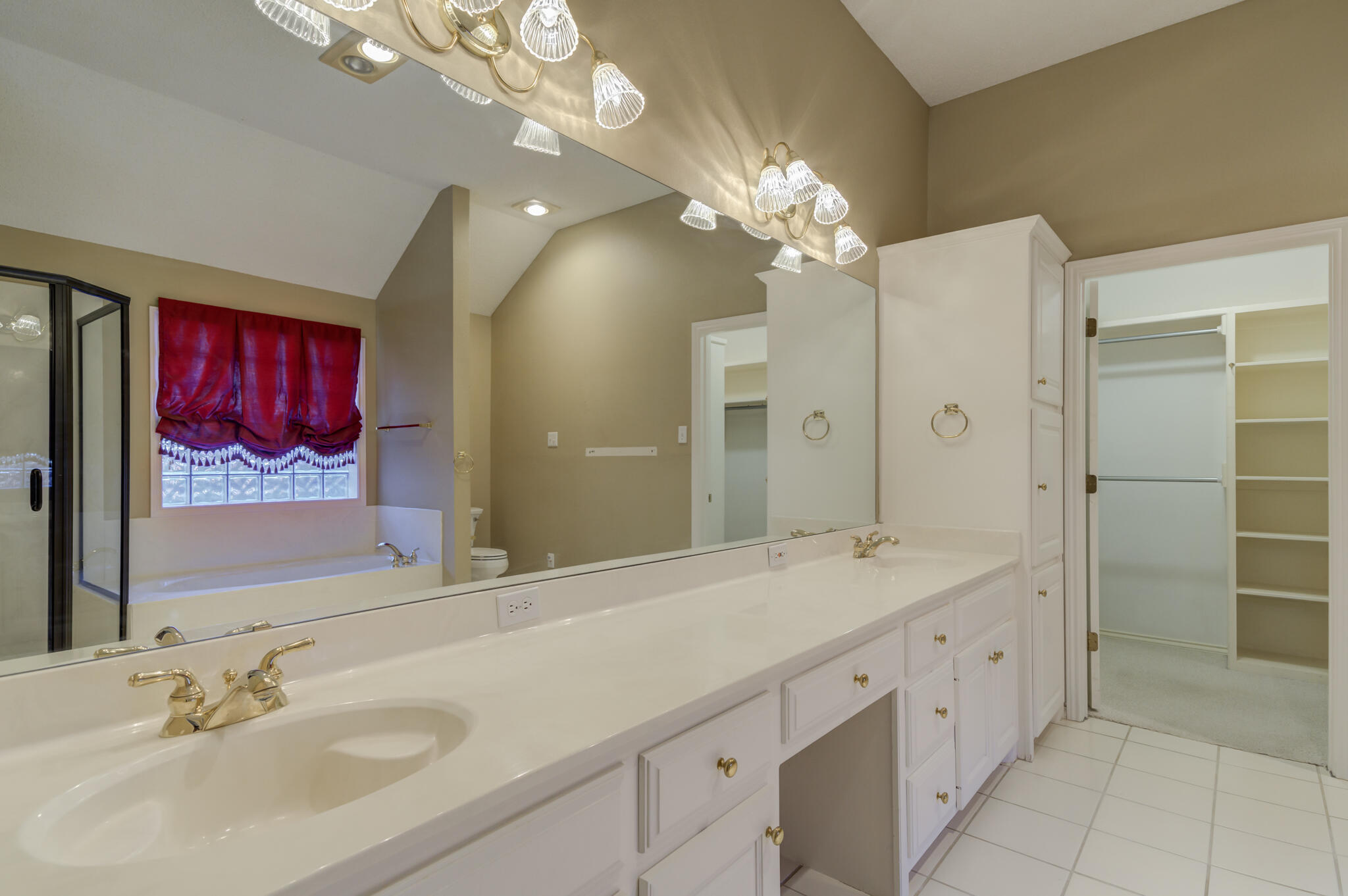 5917 85th Street Lubbock, TX 79424 - Photo 33 of 51 a bathroom with a granite countertop double vanity sink a shower and a mirror