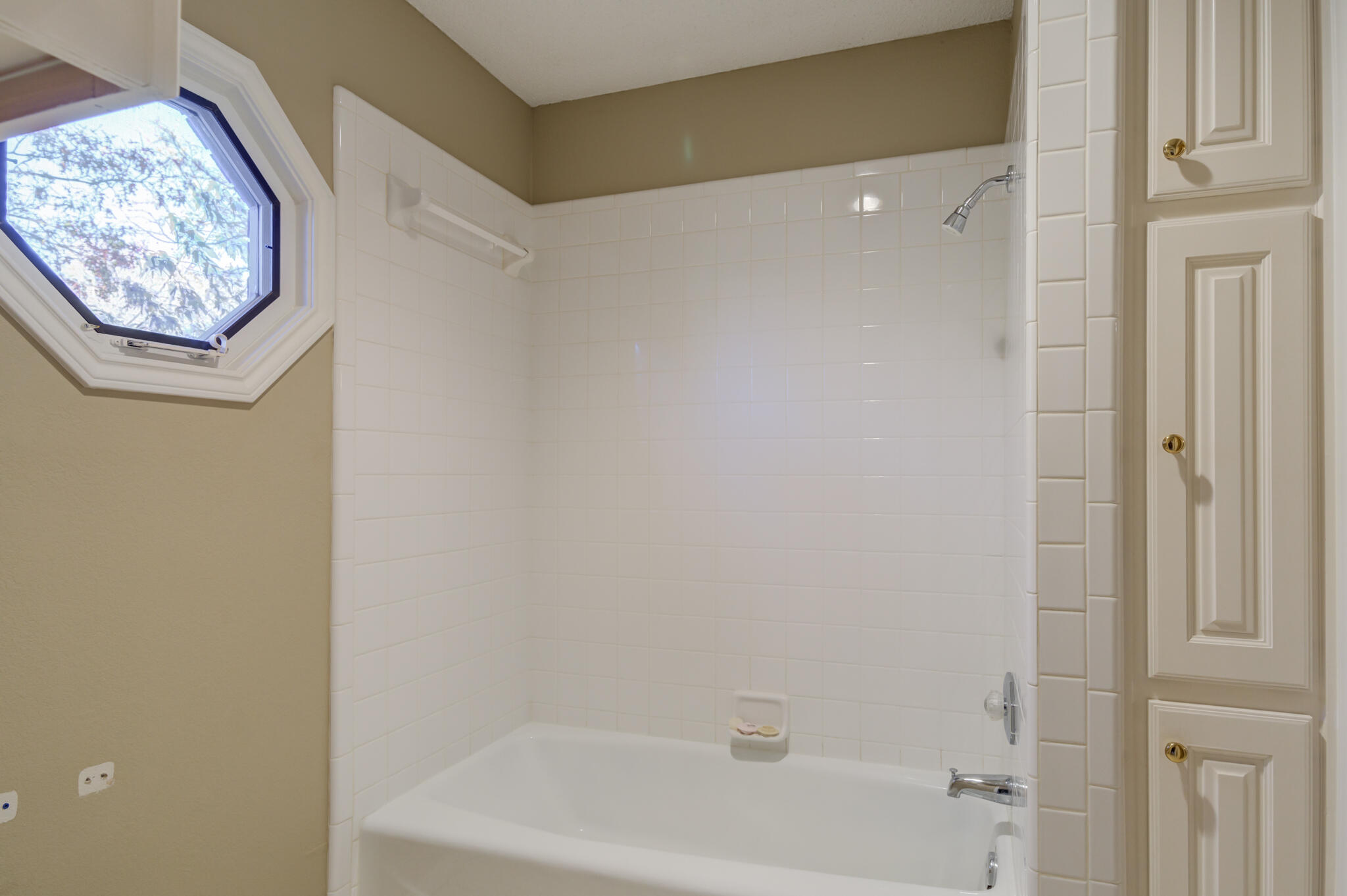5917 85th Street Lubbock, TX 79424 - Photo 40 of 51 a bathroom with a bathtub and a shower