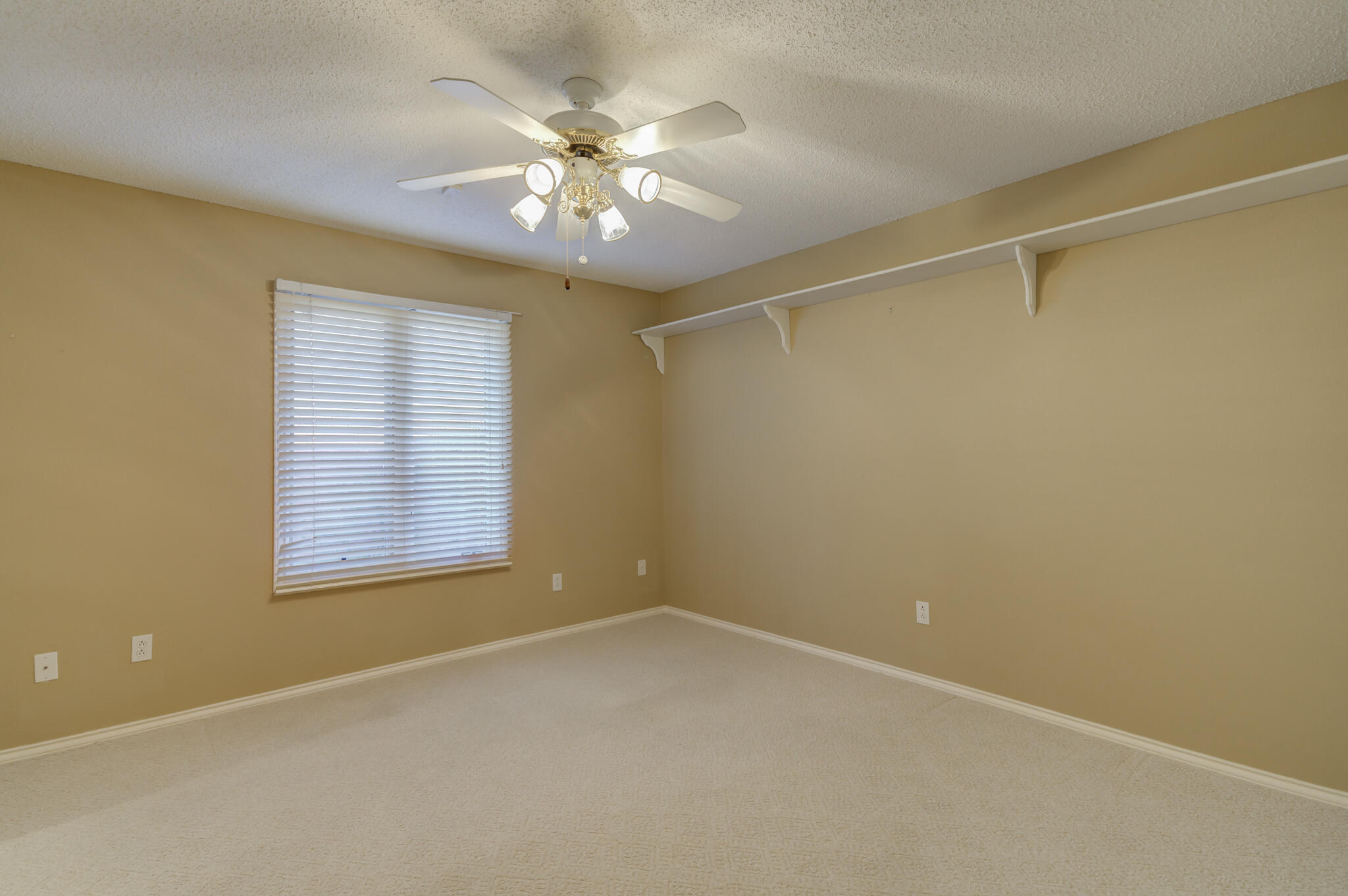 5917 85th Street Lubbock, TX 79424 - Photo 44 of 51 an empty room with a chandelier fan and windows