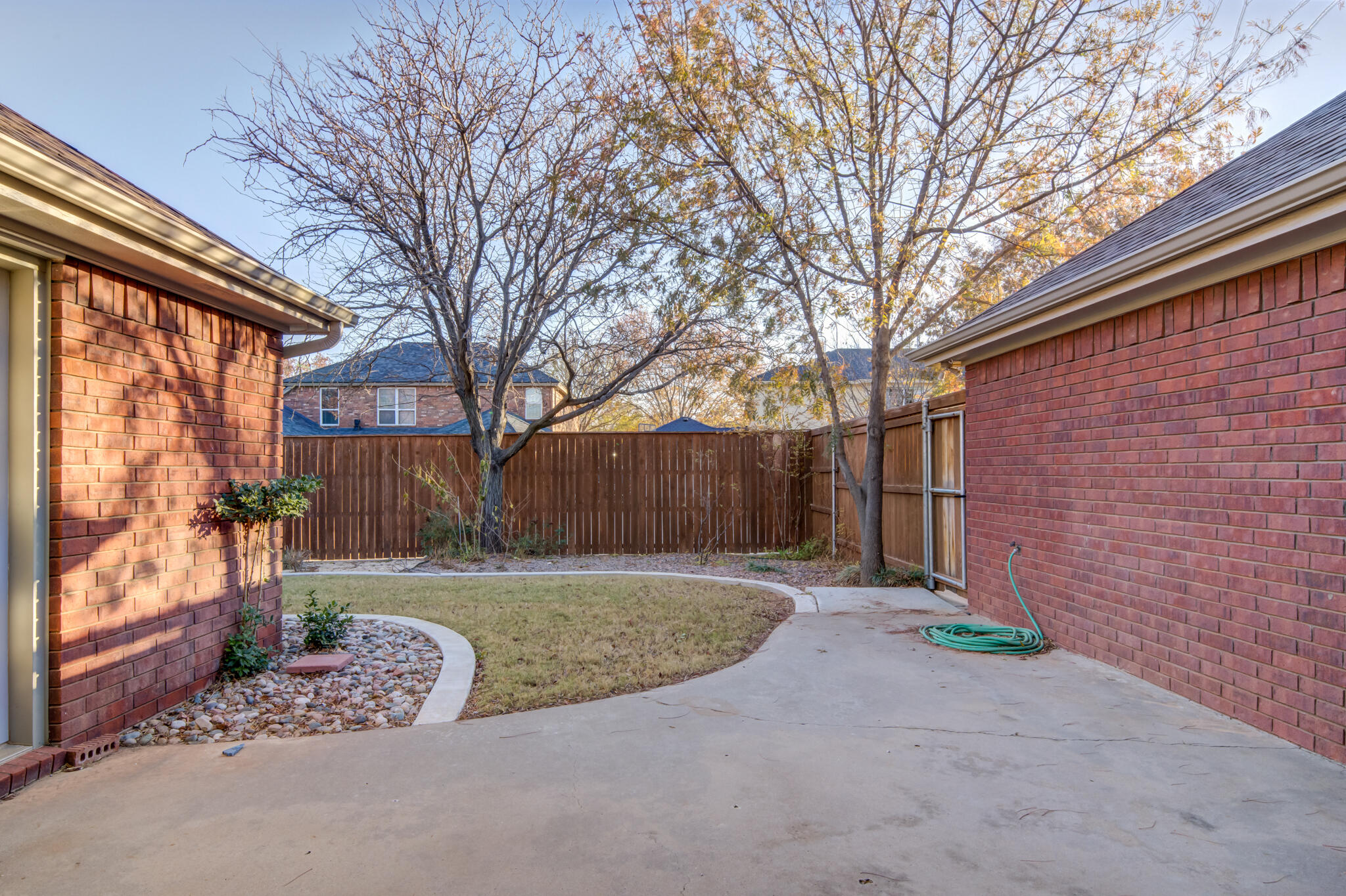 5917 85th Street Lubbock, TX 79424 - Photo 47 of 51 a view of a backyard with large trees and plants