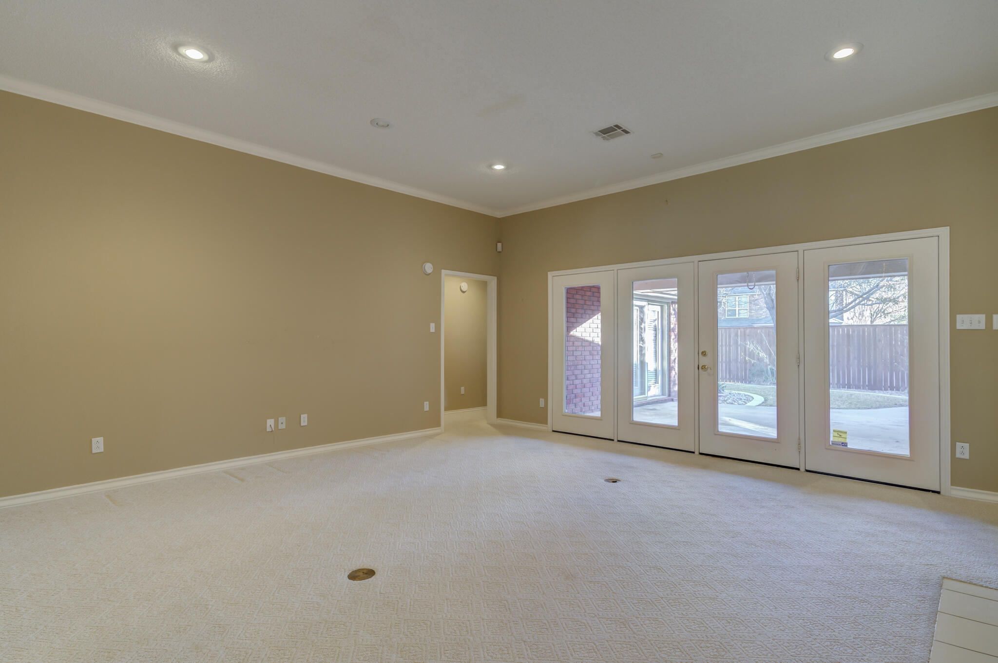 5917 85th Street Lubbock, TX 79424 - Photo 8 of 51 a view of an empty room with a fireplace and a large window