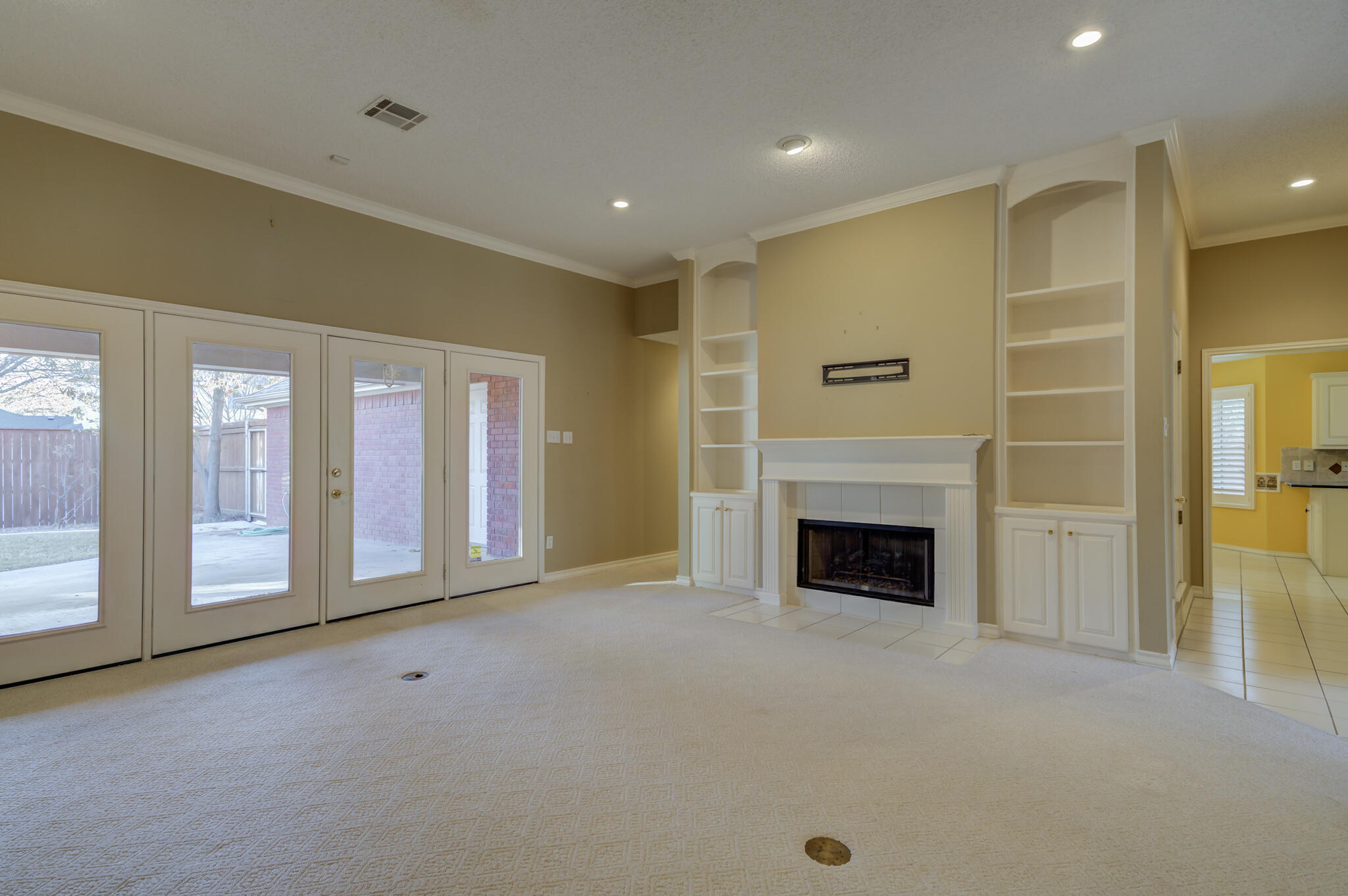 5917 85th Street Lubbock, TX 79424 - Photo 10 of 51 a view of a livingroom with a fireplace cabinet and windows