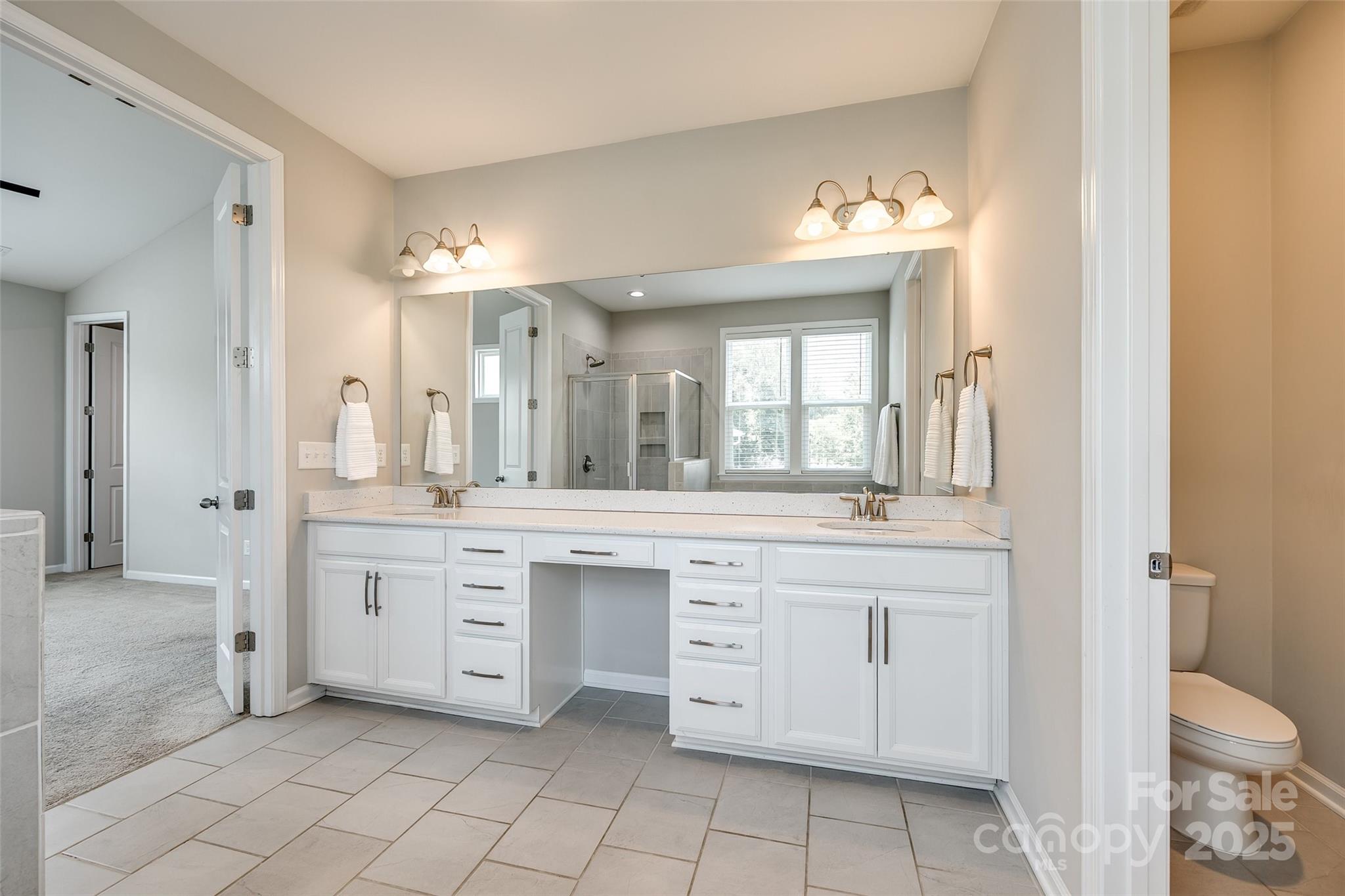 173 Morgan's Branch Road Belmont, NC 28012 - Photo 13 of 29 a spacious bathroom with a granite countertop sink toilet a mirror and a bathtub