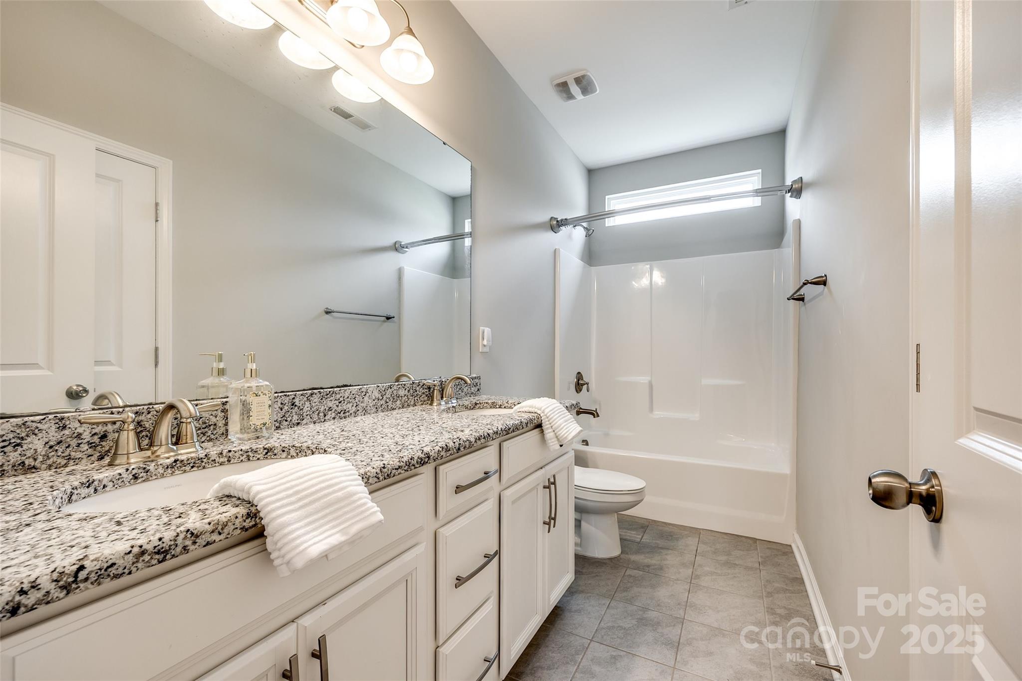 173 Morgan's Branch Road Belmont, NC 28012 - Photo 23 of 29 a bathroom with a granite countertop sink toilet and shower