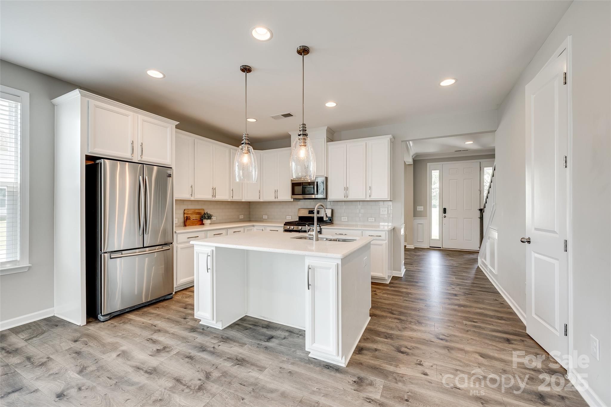 173 Morgan's Branch Road Belmont, NC 28012 - Photo 3 of 29 a kitchen with refrigerator cabinets and wooden floor