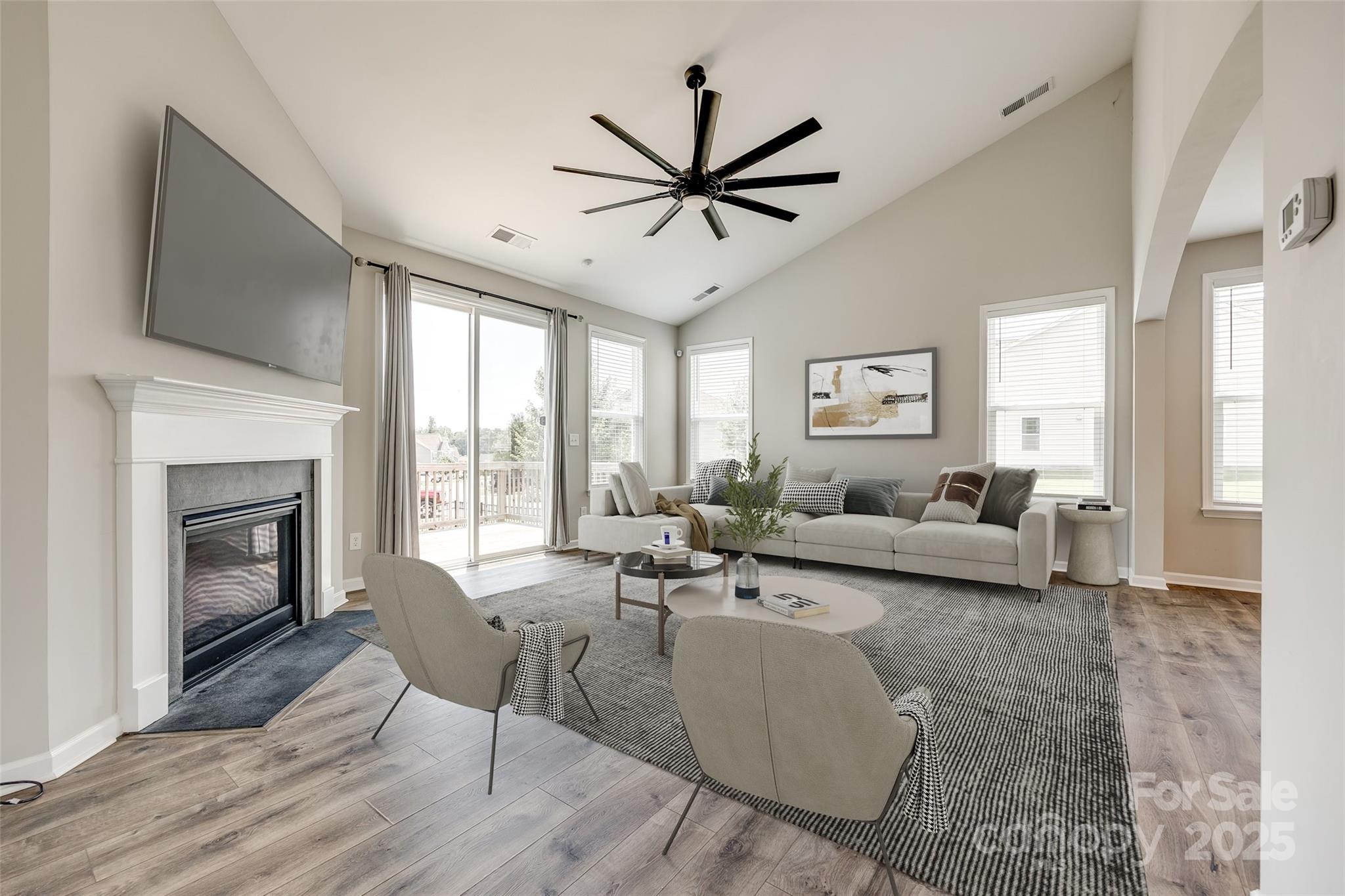 173 Morgan's Branch Road Belmont, NC 28012 - Photo 8 of 29 a living room with furniture a fireplace and a flat screen tv