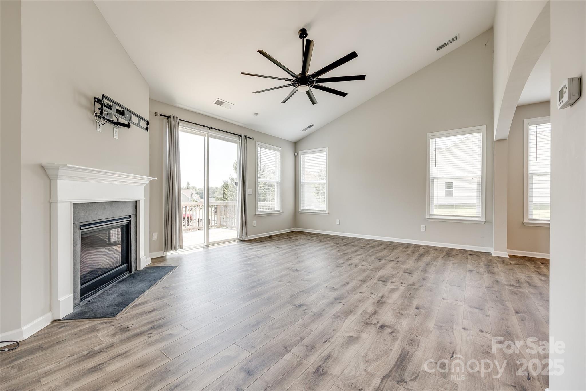 173 Morgan's Branch Road Belmont, NC 28012 - Photo 9 of 29 a view of empty room with wooden floor and fireplace