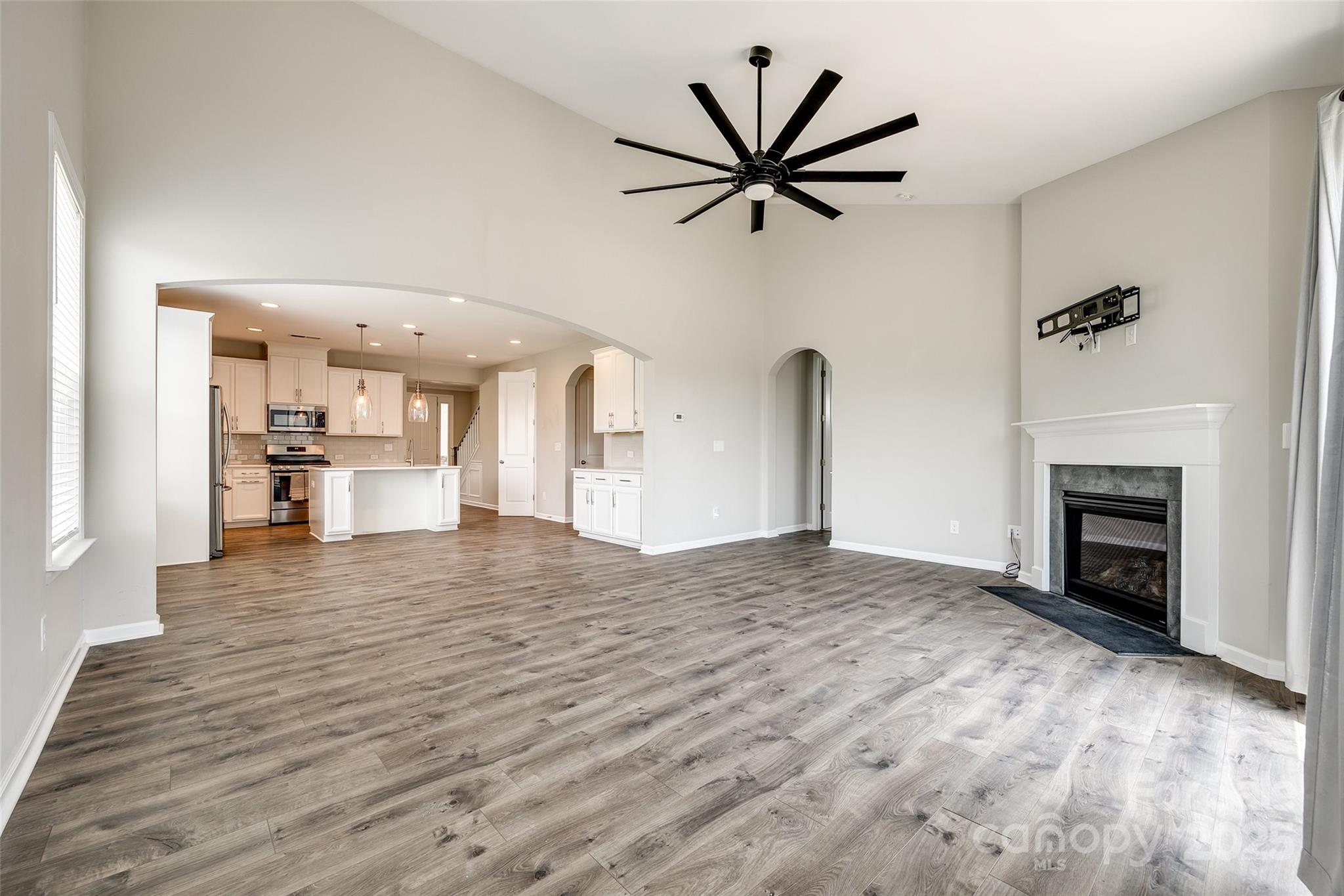 173 Morgan's Branch Road Belmont, NC 28012 - Photo 10 of 29 a view of a livingroom with a fireplace a ceiling fan and wooden floor