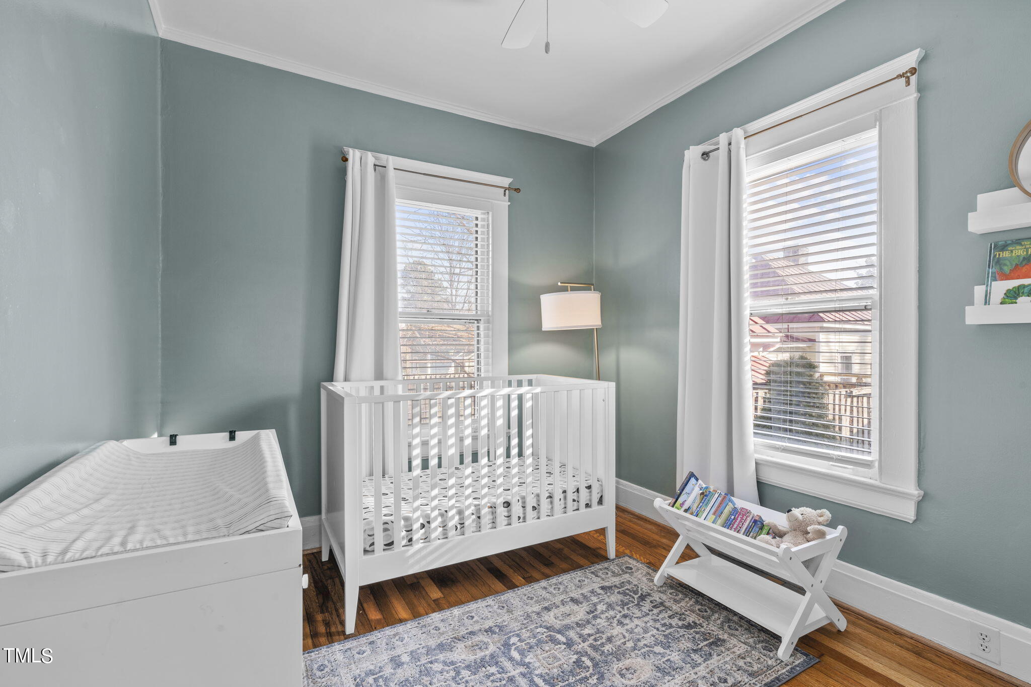 529 Euclid Street Raleigh, NC 27604 - Photo 11 of 37 a bedroom with a baby bed a couch and a window