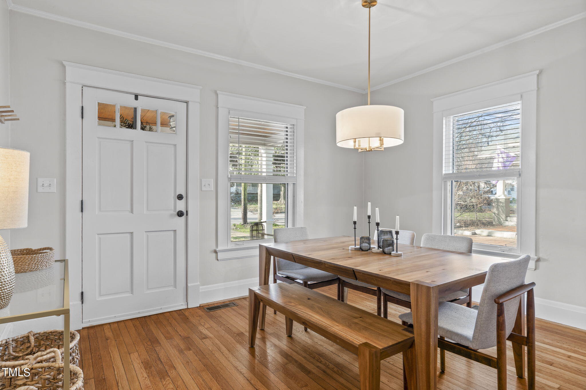 529 Euclid Street Raleigh, NC 27604 - Photo 5 of 37 a dining room with wooden floor a chandelier a wooden table and chairs