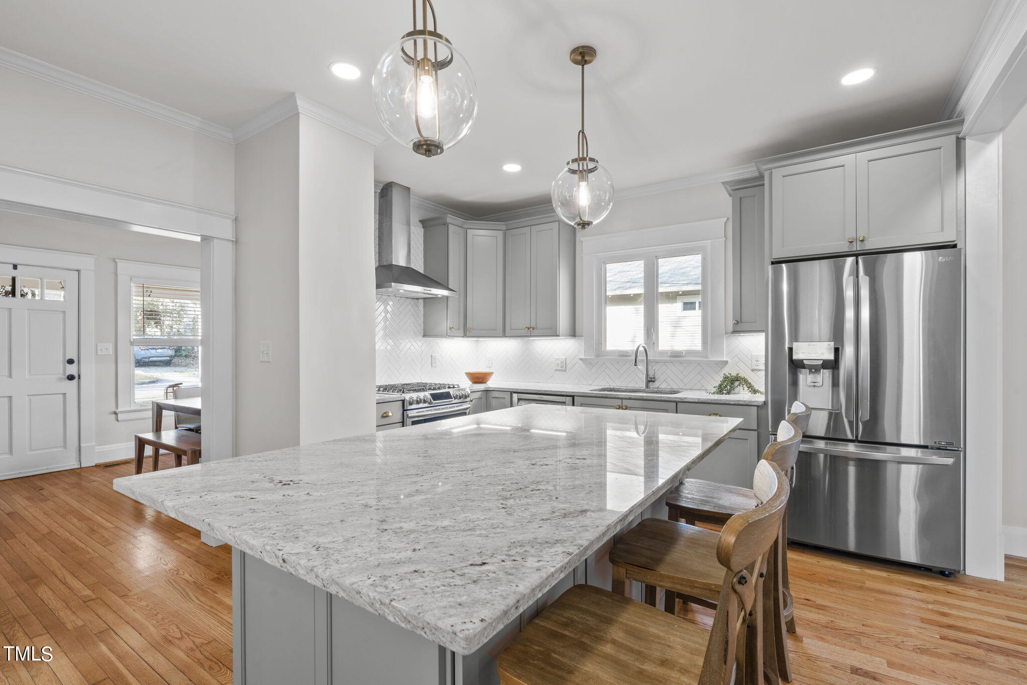 529 Euclid Street Raleigh, NC 27604 - Photo 7 of 37 a kitchen with stainless steel appliances granite countertop wooden floor window and refrigerator