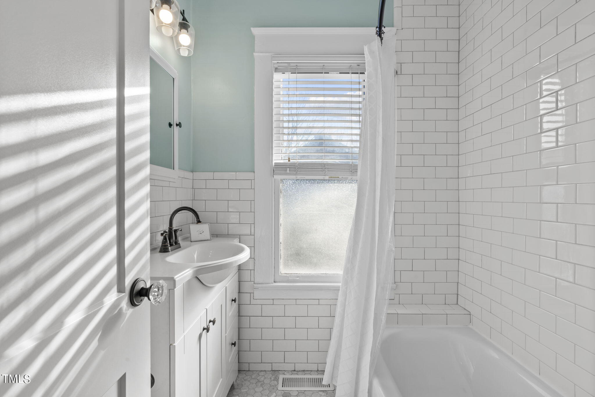 529 Euclid Street Raleigh, NC 27604 - Photo 10 of 37 a bathroom with a sink a mirror and shower