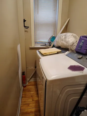 a room with water heater and wooden cabinets