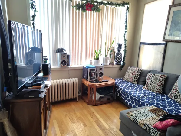 a bedroom with furniture and a large window