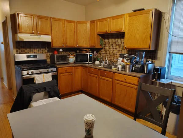 a kitchen with stainless steel appliances granite countertop a refrigerator sink and cabinets