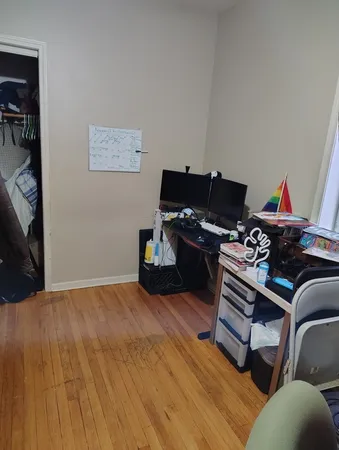 a bedroom with a bed and a black white wall