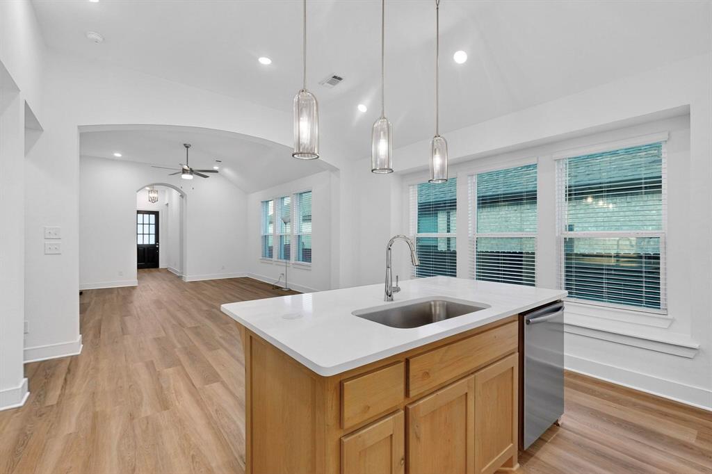 1232 Newport Street Sherman, TX 75090 - Photo 12 of 40 a kitchen with a sink a counter space and living room view