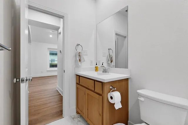 a bathroom with a sink a toilet and a mirror