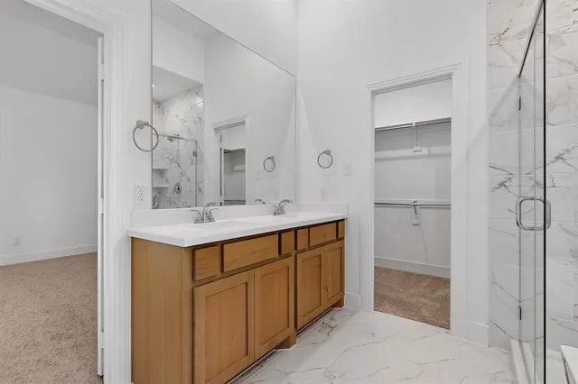 a bathroom with a sink a mirror and a shower