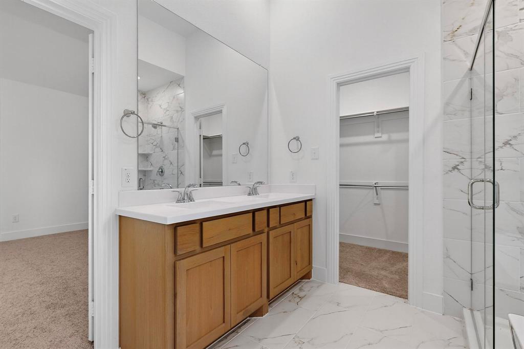 1232 Newport Street Sherman, TX 75090 - Photo 20 of 40 a bathroom with a sink a mirror and a shower