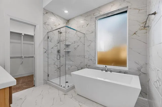a bathroom with a bathtub and a shower