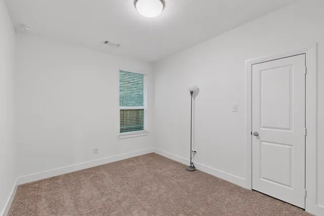 a view of an empty room with closet area