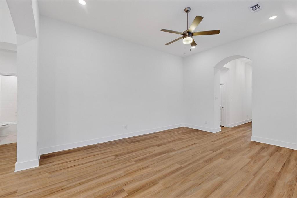 1232 Newport Street Sherman, TX 75090 - Photo 5 of 40 a view of a room with wooden floor and a ceiling fan