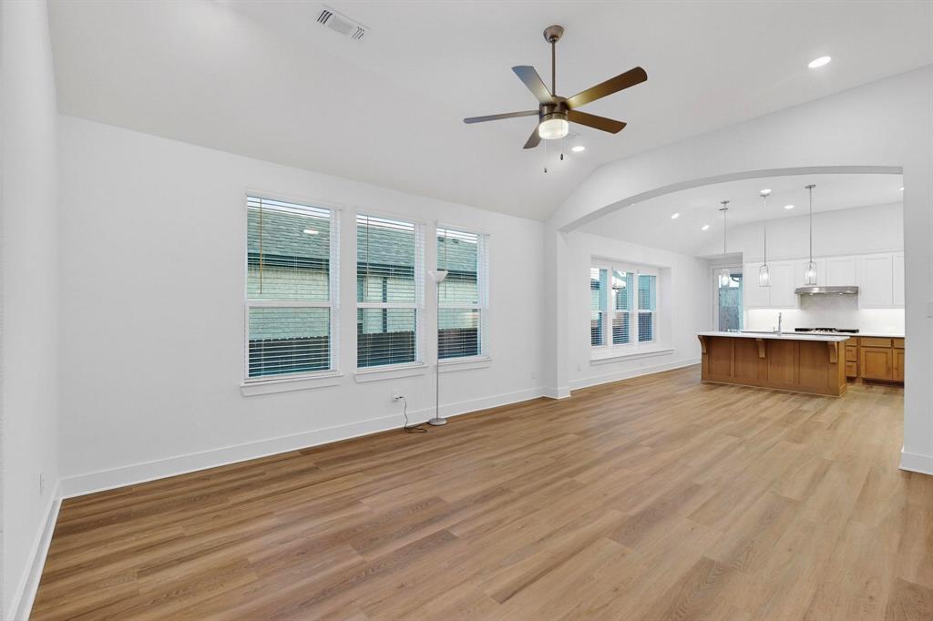 1232 Newport Street Sherman, TX 75090 - Photo 7 of 40 a view of an empty room with a window and wooden floor