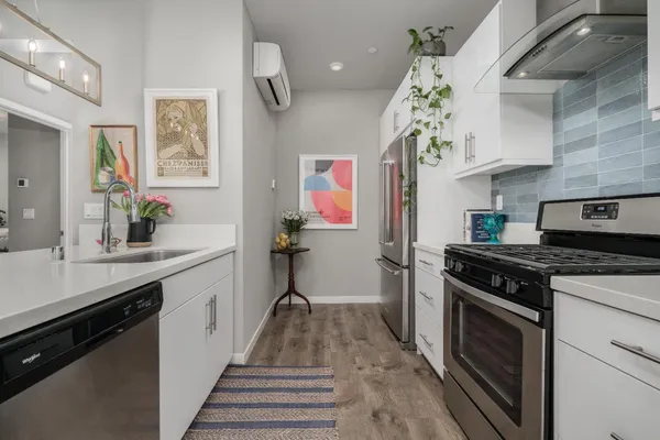 a view of living room with kitchen island furniture and a chandelier