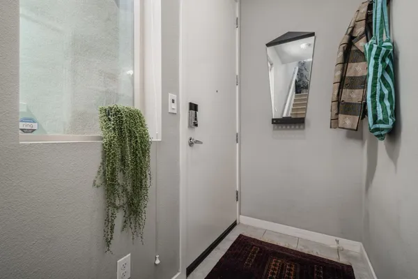 a living room with furniture and a potted plant