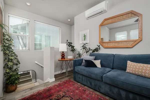 a living room with furniture and a potted plant