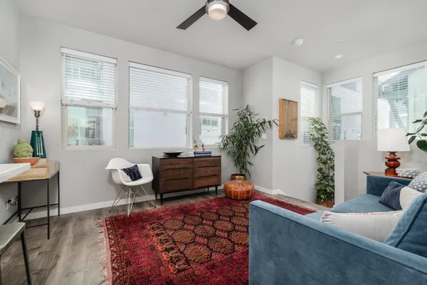 a kitchen with stainless steel appliances granite countertop a table chairs refrigerator and sink