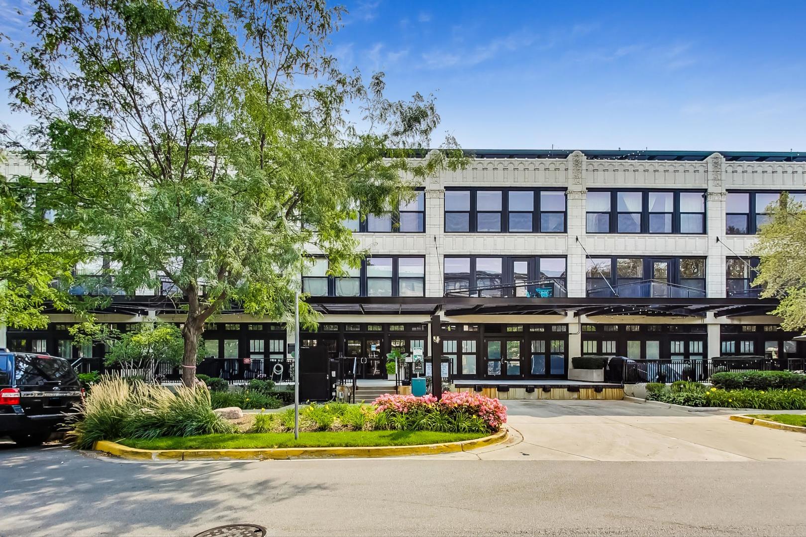 a front view of building with cars parked