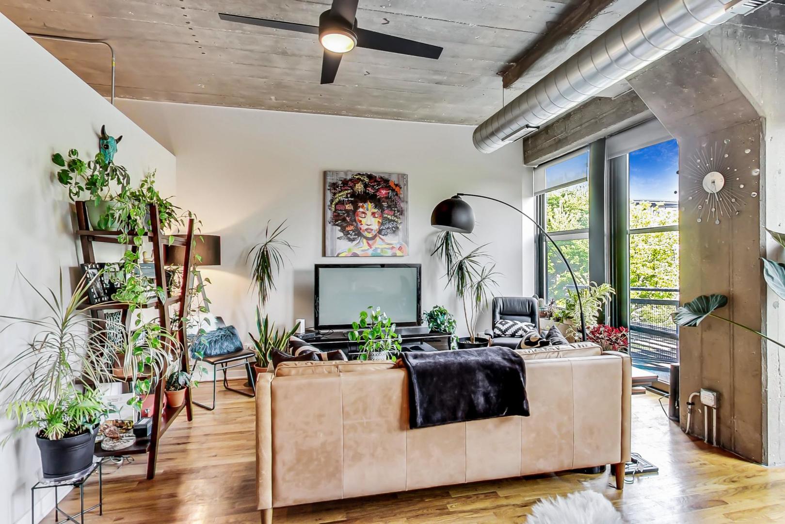 1111 West 15th Street, Unit 221 Chicago, IL 60608 - Photo 2 of 21 a living room with furniture and a large window