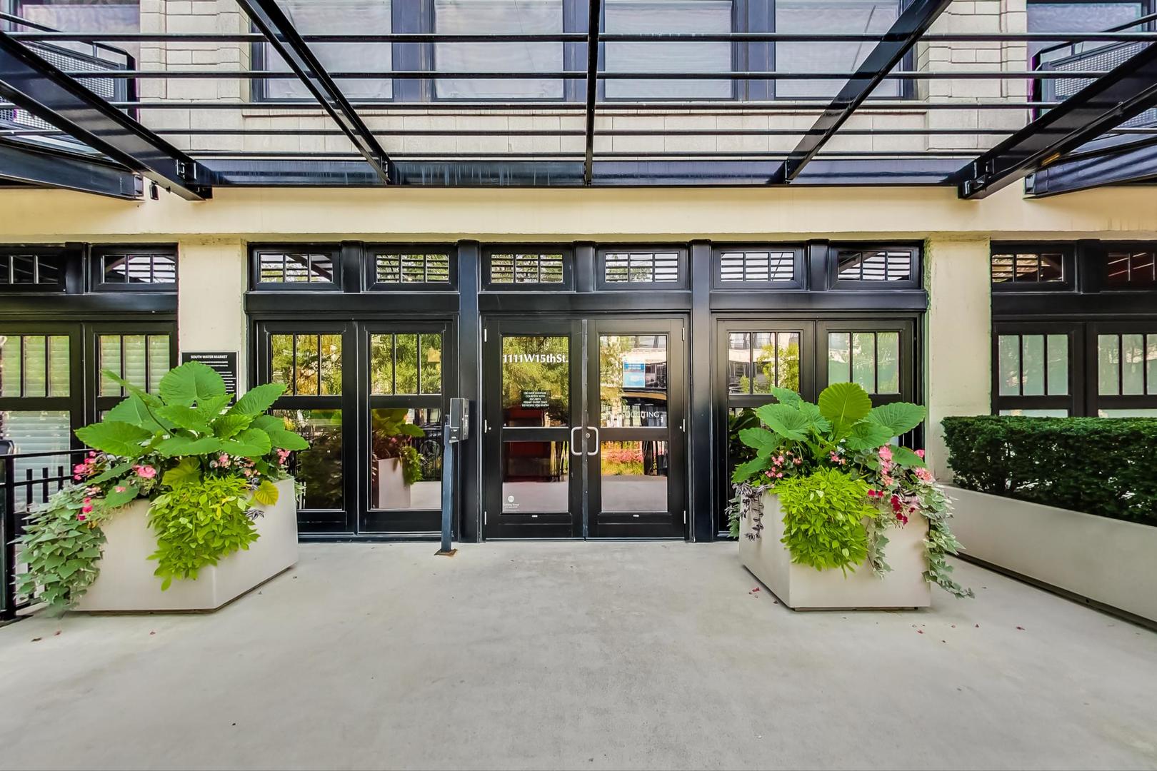 1111 West 15th Street, Unit 221 Chicago, IL 60608 - Photo 18 of 21 front view of a building with potted plants