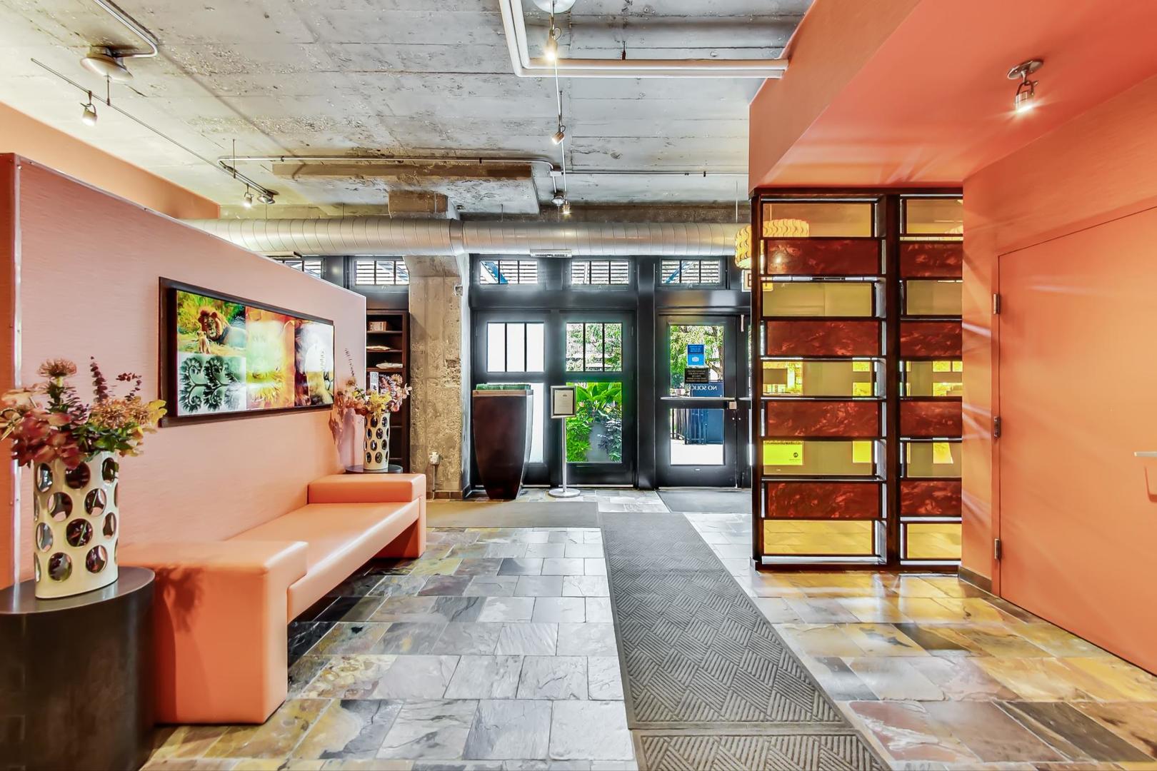 1111 West 15th Street, Unit 221 Chicago, IL 60608 - Photo 20 of 21 a lobby with furniture and floor to ceiling window