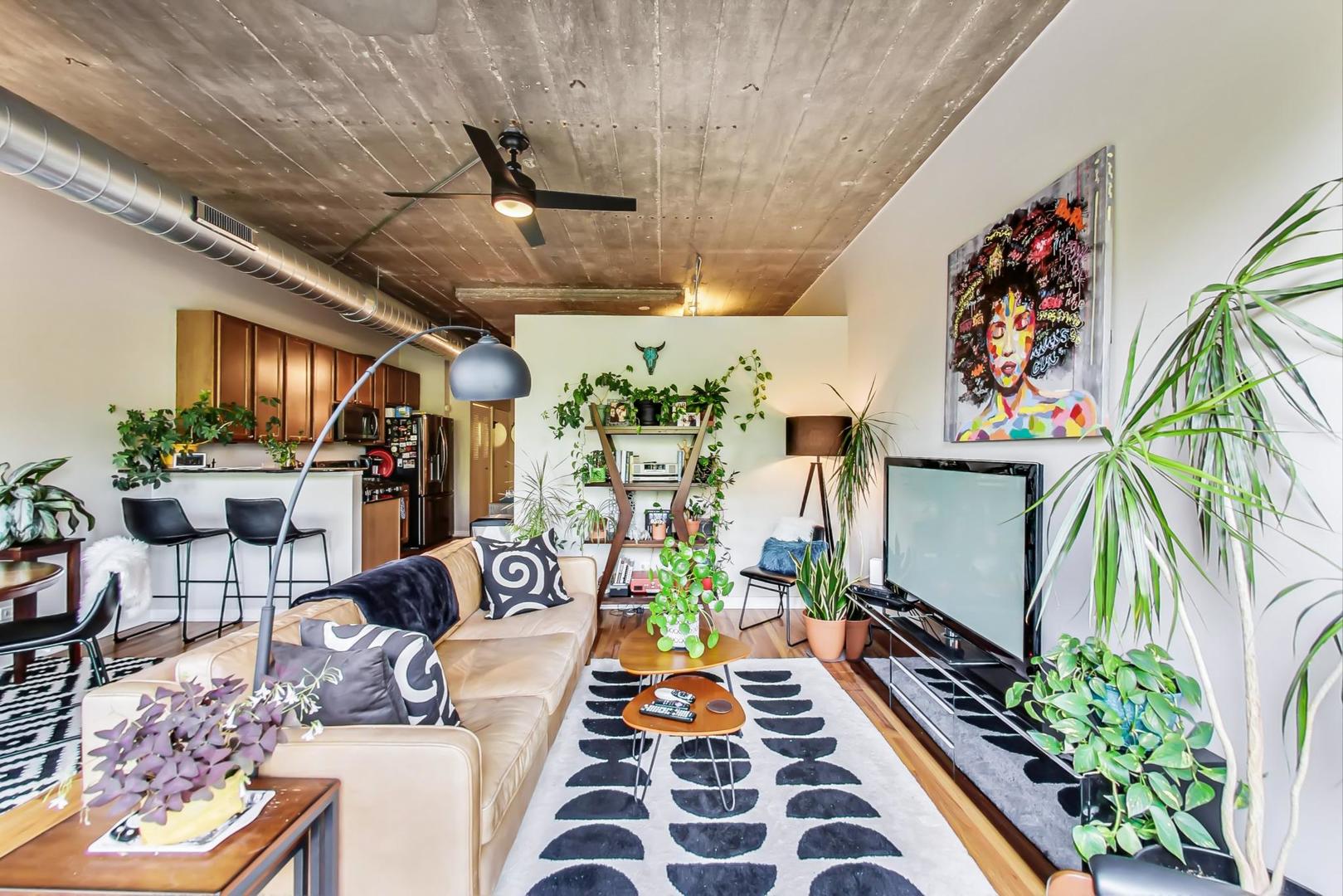 1111 West 15th Street, Unit 221 Chicago, IL 60608 - Photo 3 of 21 a living room with patio furniture and a potted plant
