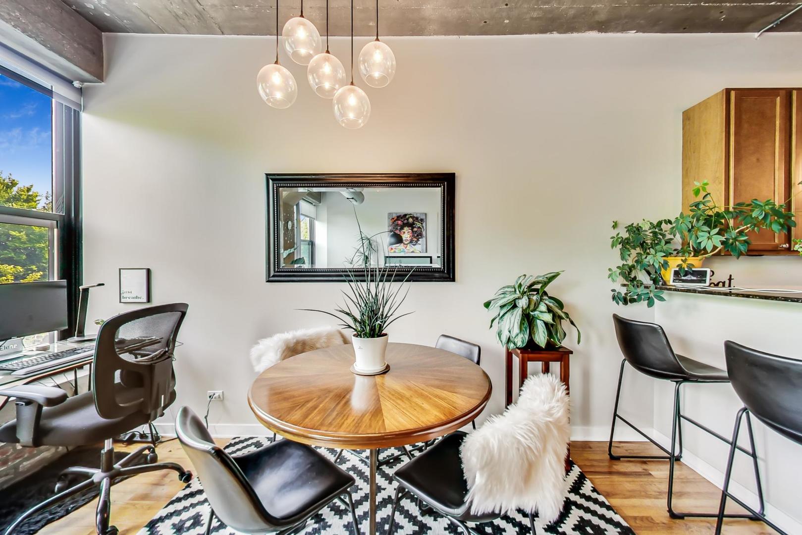 1111 West 15th Street, Unit 221 Chicago, IL 60608 - Photo 7 of 21 a dining room with furniture and wooden floor