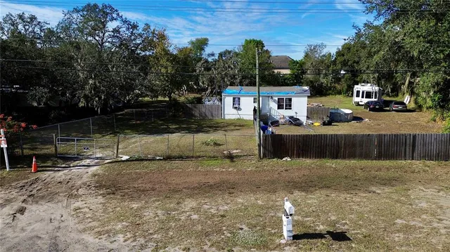 a view of a chairs and table in the back yard