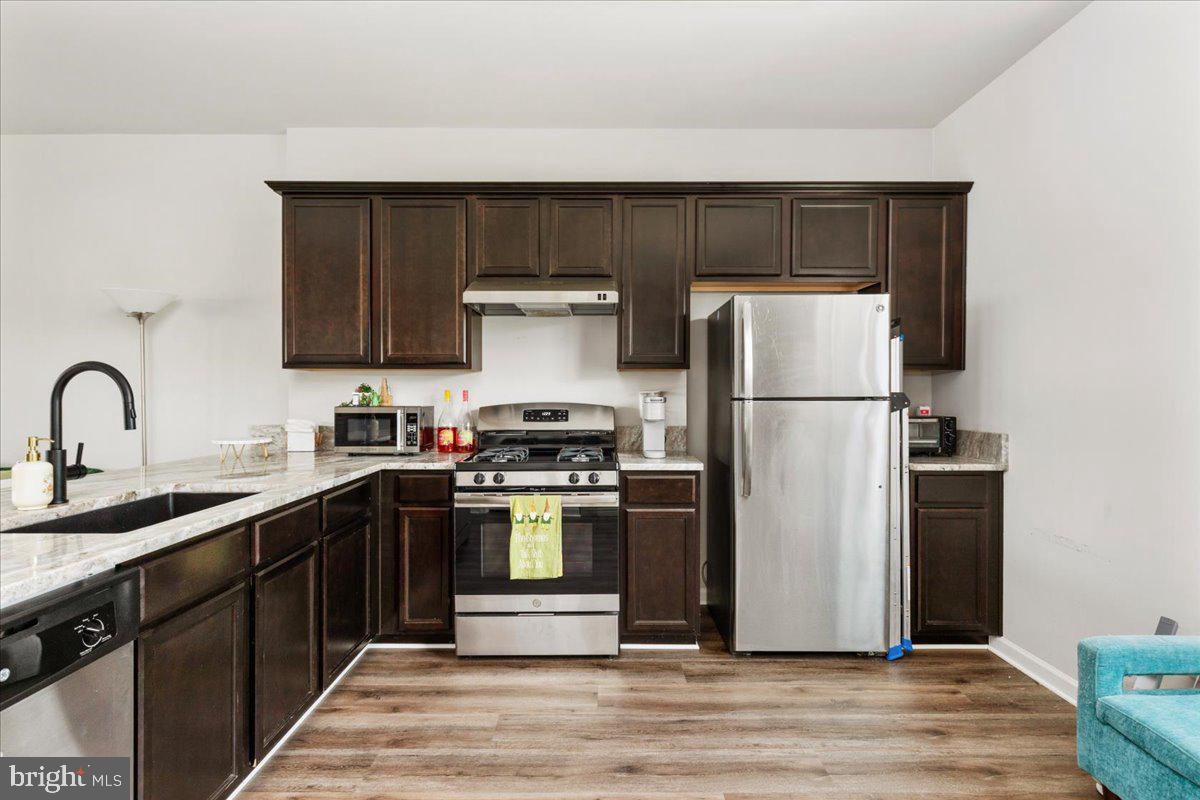 267 Patchwork Drive Stephenson, VA 22656 - Photo 12 of 41 a kitchen with a refrigerator sink and white cabinets