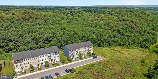 an aerial view of a house with pool outdoor seating and yard