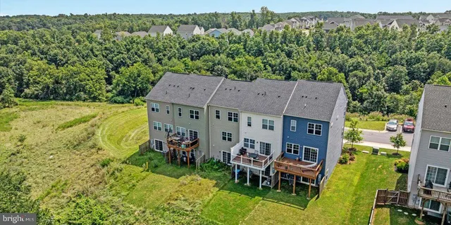 an aerial view of a house with swimming pool and garden