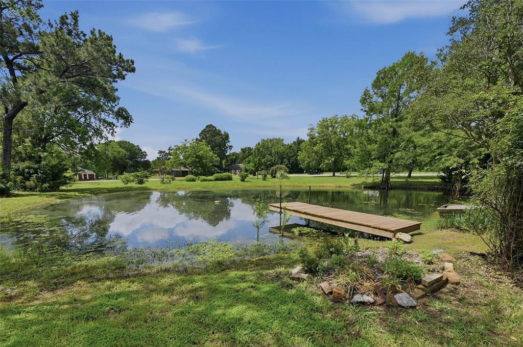 522 High Country Road Sherman, TX 75092 - Photo 3 of 38 a view of a lake with a yard and large trees