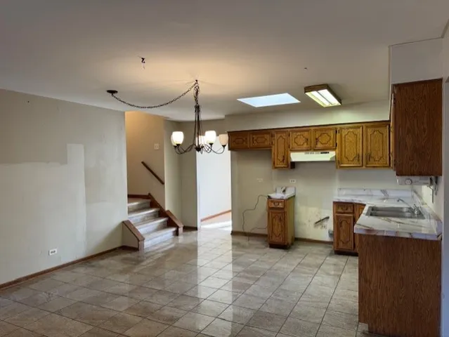 a kitchen with a sink cabinets and window