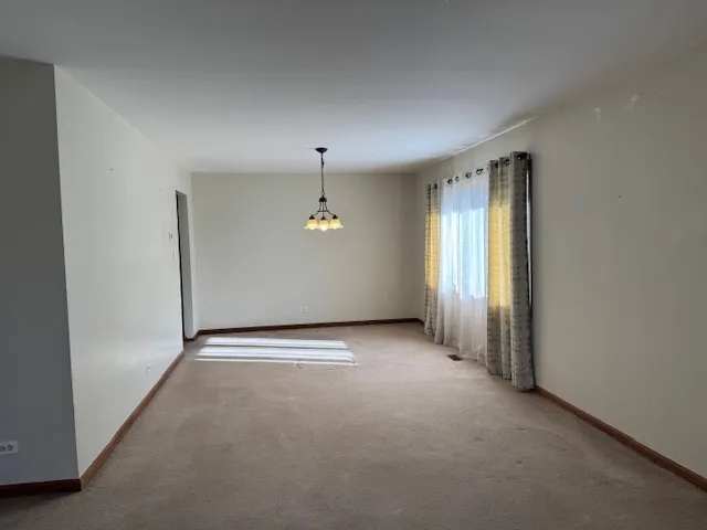 an empty room with a empty space and windows