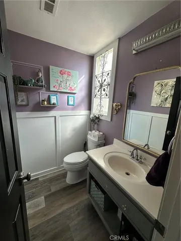 a bathroom with a sink mirror and toilet