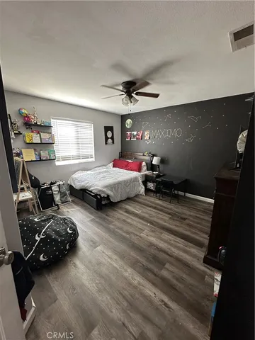 a bedroom with two beds and a chandelier
