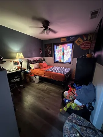 a bedroom with furniture and a ceiling fan